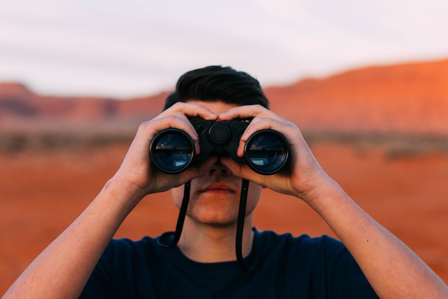 A man watching binoculars